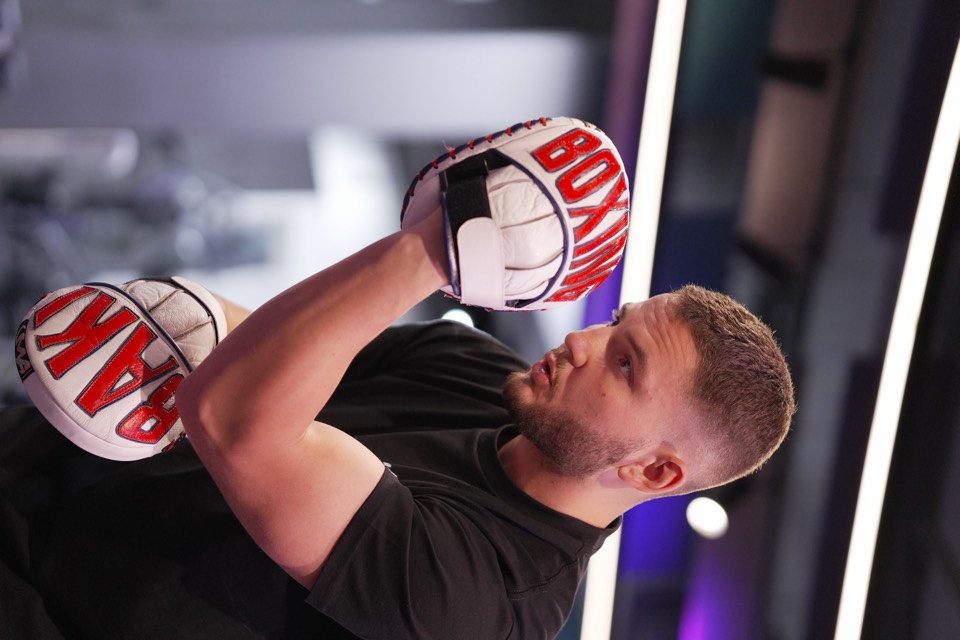 Private boxing coach Baki holding focus mitts in Wentworth Point
